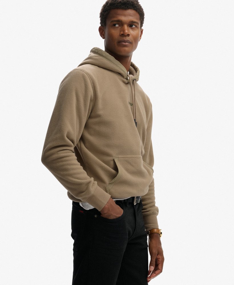 Man wearing a beige hoodie on a white background