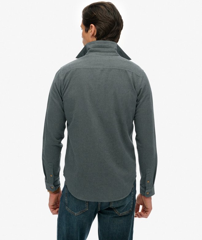 Man wearing a green long-sleeve shirt on a white background
