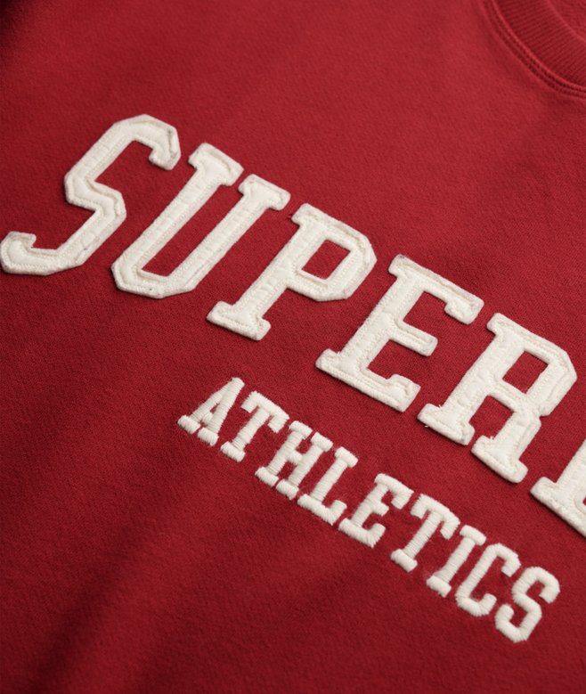 Red sweatshirt with 'Superdry' and 'Athletics' text in white