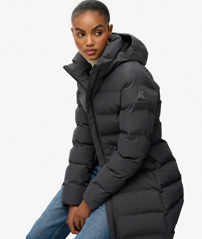 Person wearing a black puffer jacket on a white background