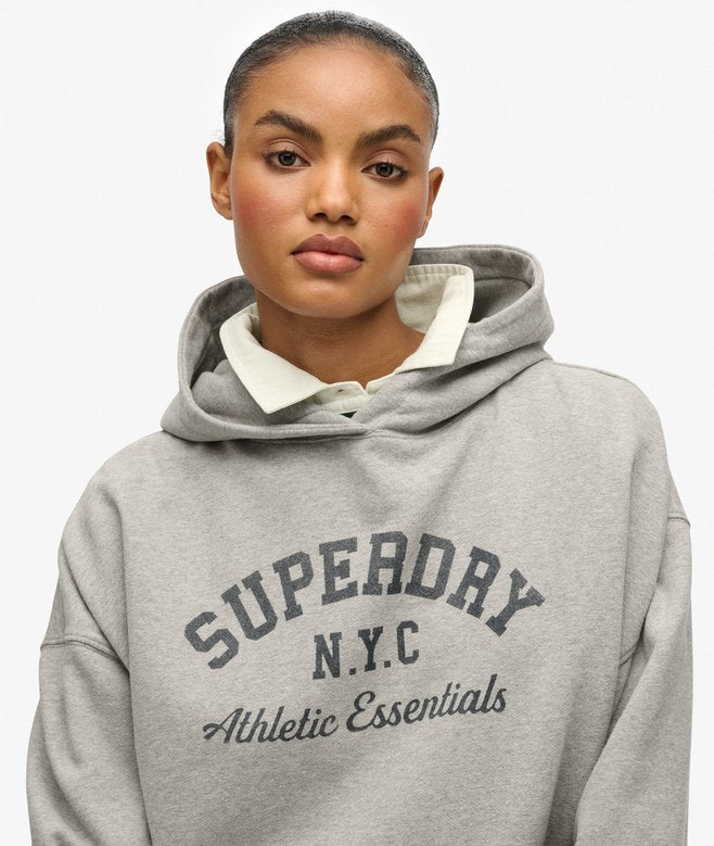 Woman wearing a gray Superdry hoodie with a white collar on a white background