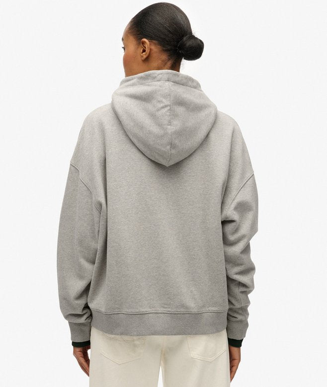 Person wearing a gray hoodie from behind on a white background