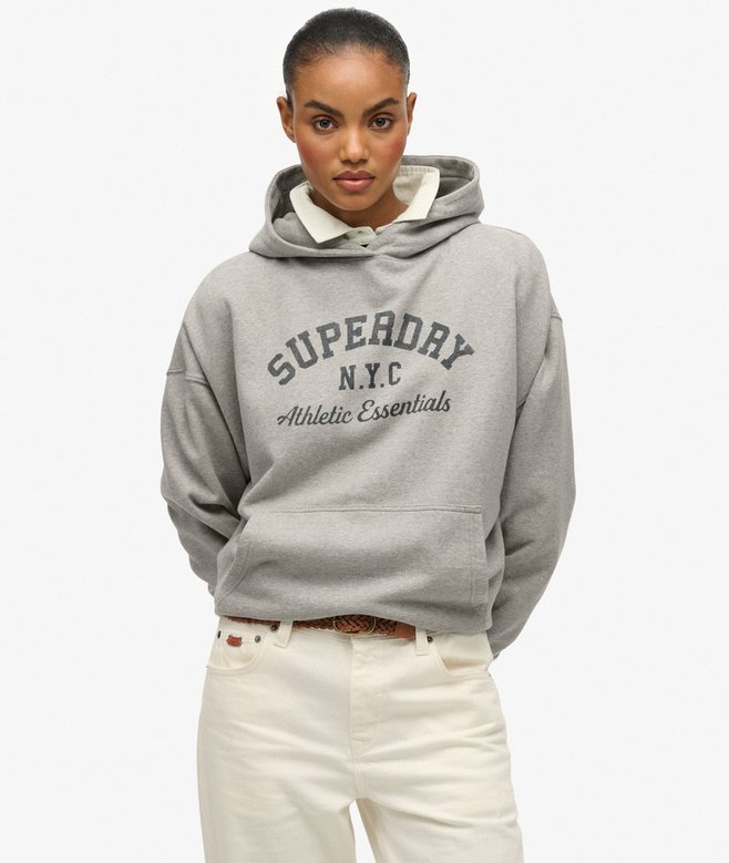 Person wearing a gray Superdry hoodie on a white background