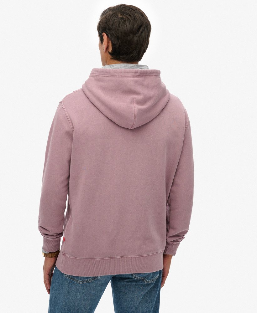 Person wearing a pink hoodie from behind on a white background