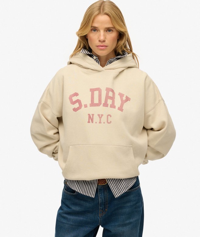 Person wearing a beige hoodie with 'S.DRY N.Y.C.' text on a white background