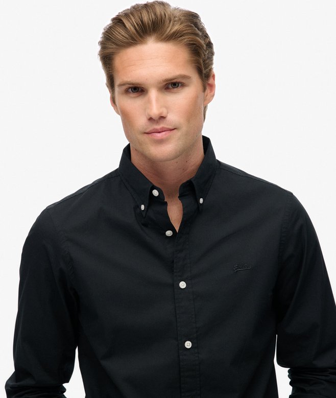 Man wearing a black shirt against a white background
