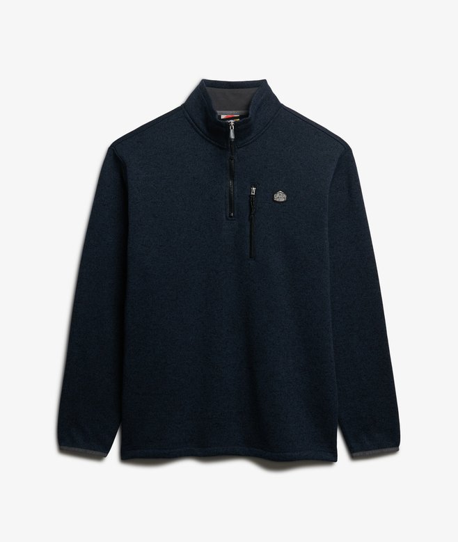 Navy blue long-sleeve shirt with a small logo on a light gray background