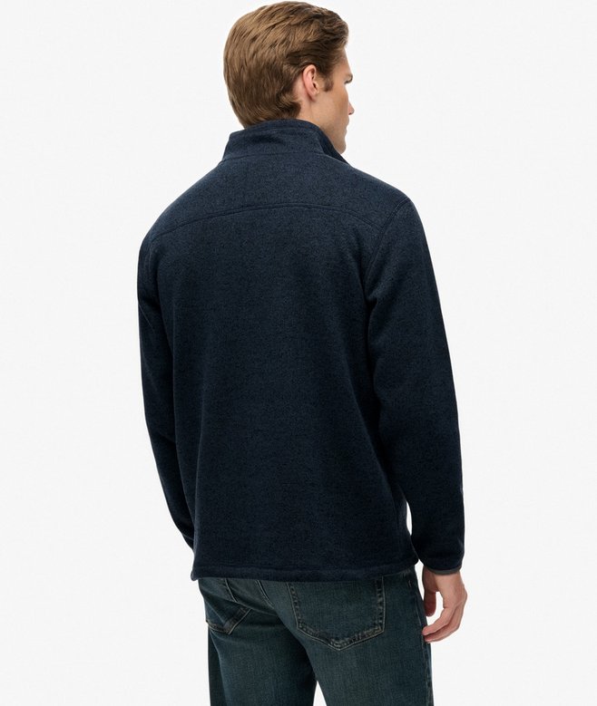Man wearing a navy blue fleece jacket on a white background