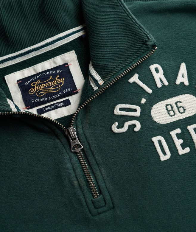 Green sweatshirt with Superdry label close up