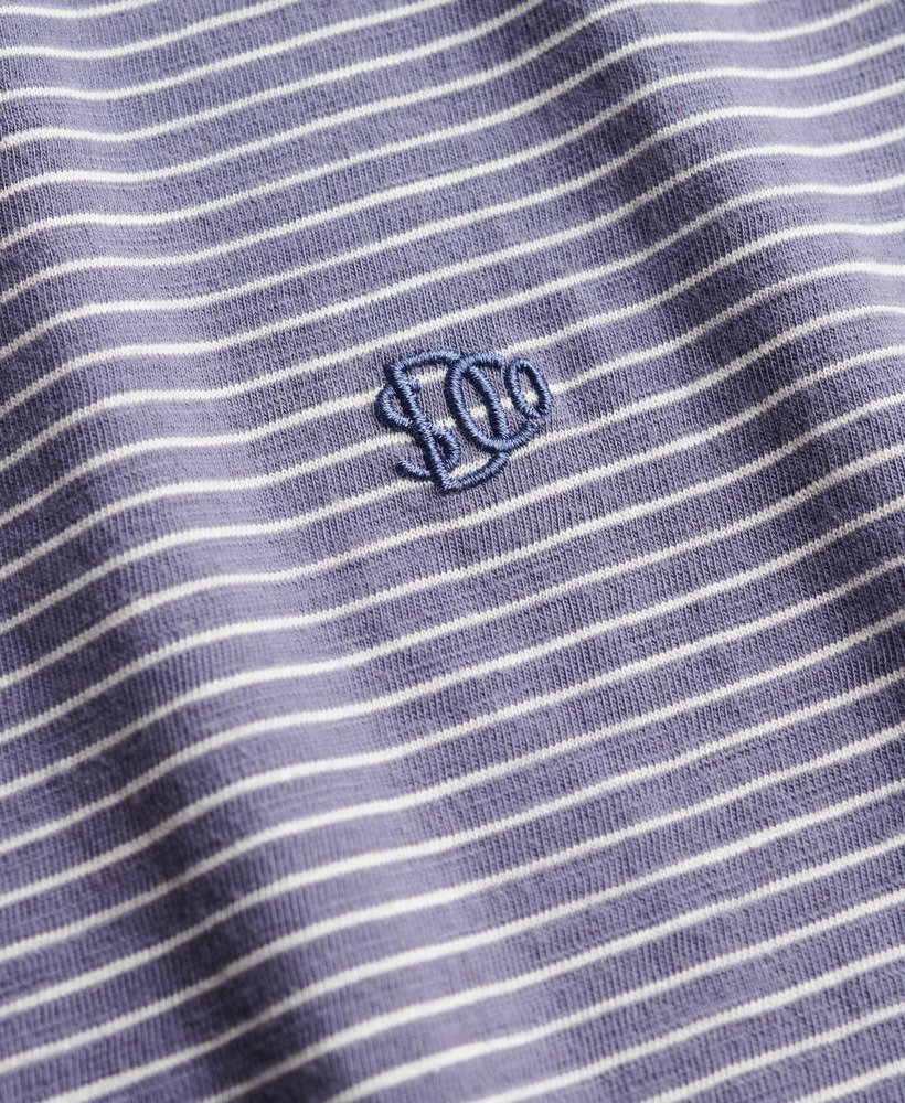 Close-up of a blue and white striped fabric with a logo in the center.