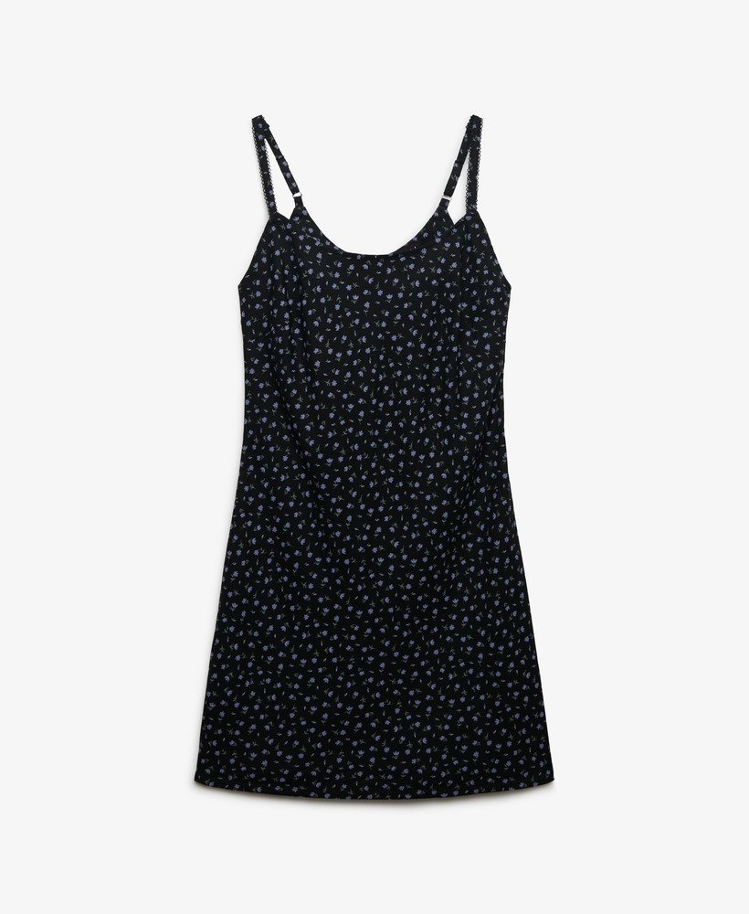 Black slip dress with white floral pattern on a white background