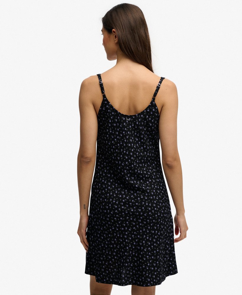 Woman wearing a black patterned dress on a white background