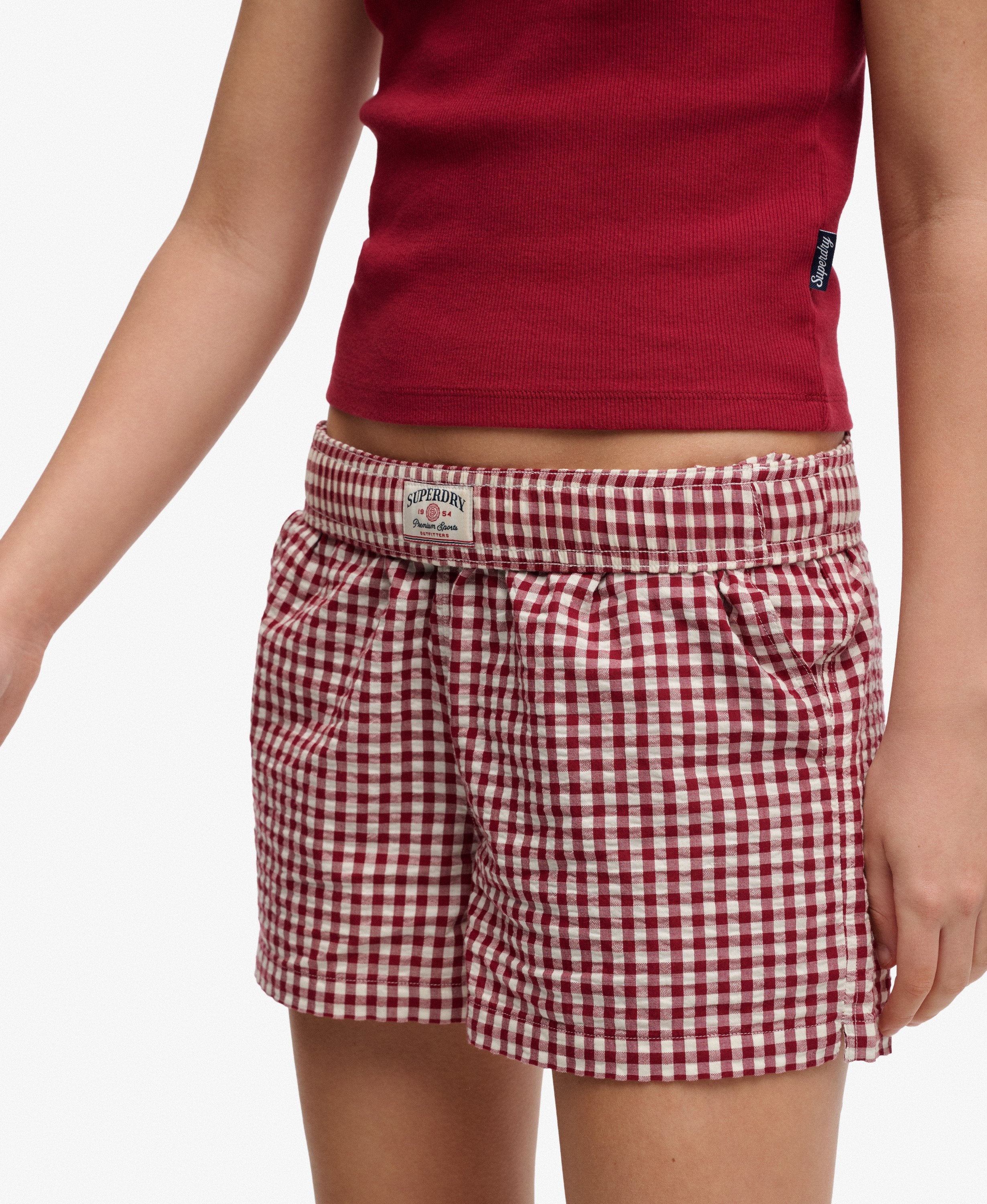 Red checkered shorts worn by a person on a white background