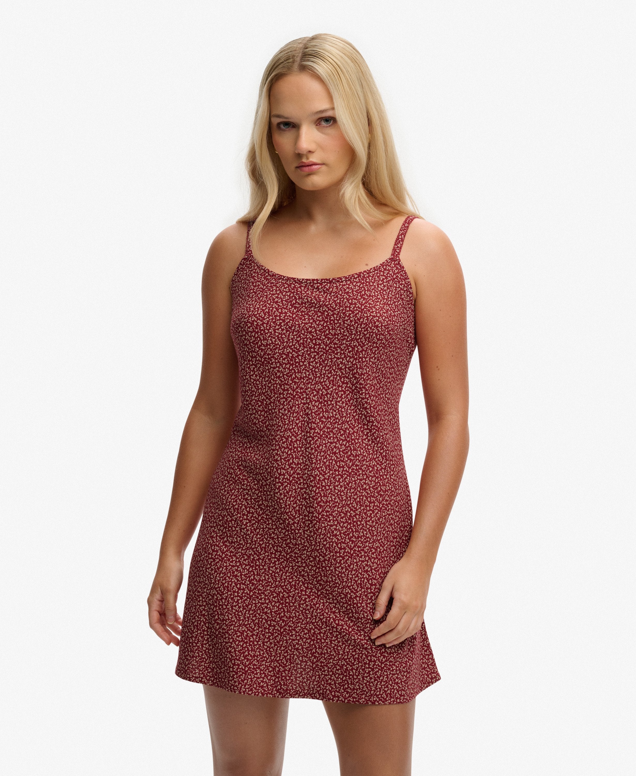 Woman wearing a red patterned dress on a white background