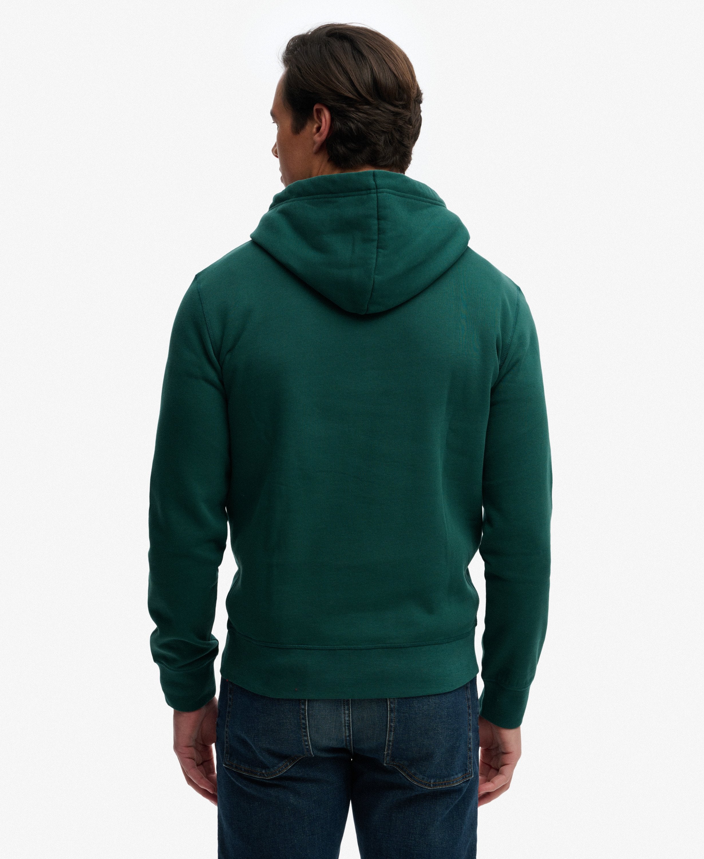 Person wearing a green hoodie from behind on a white background