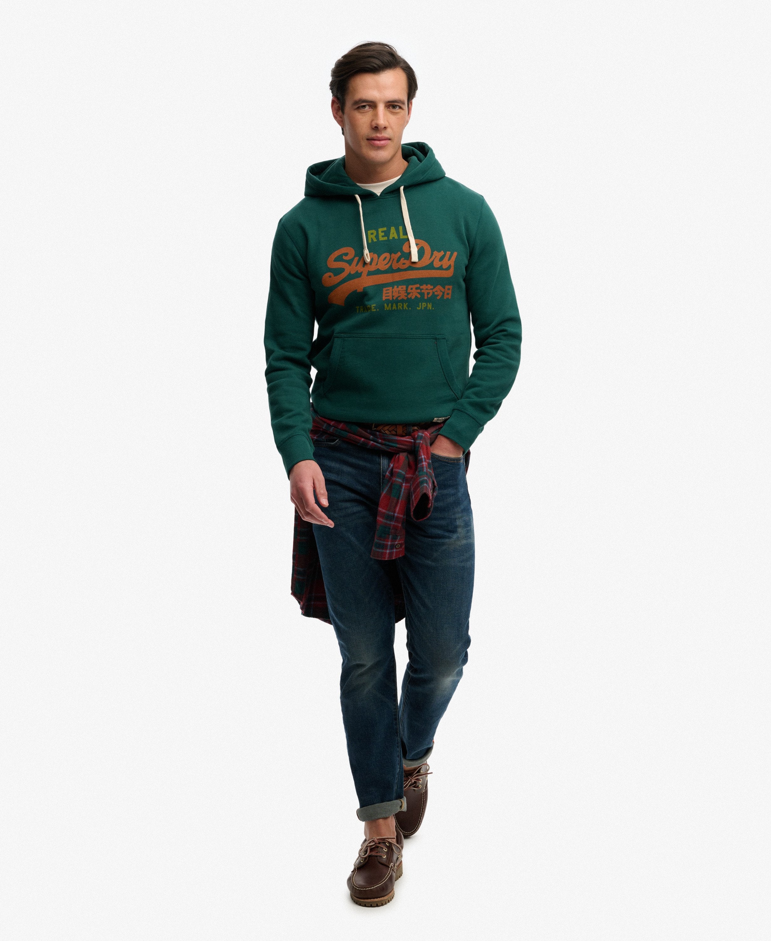 Man wearing a green hoodie with a brand logo on a white background