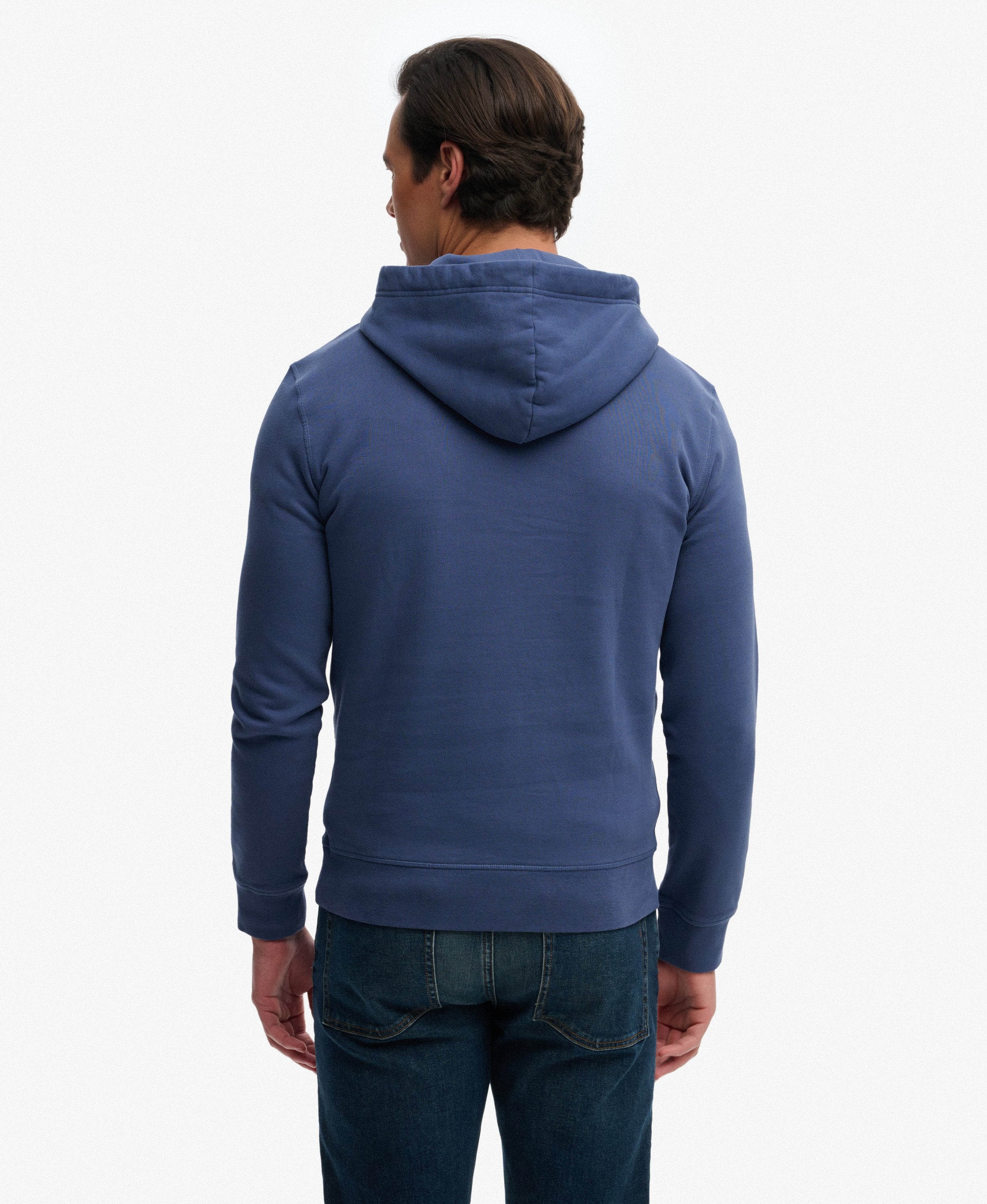 Man wearing a blue hoodie from behind on a white background