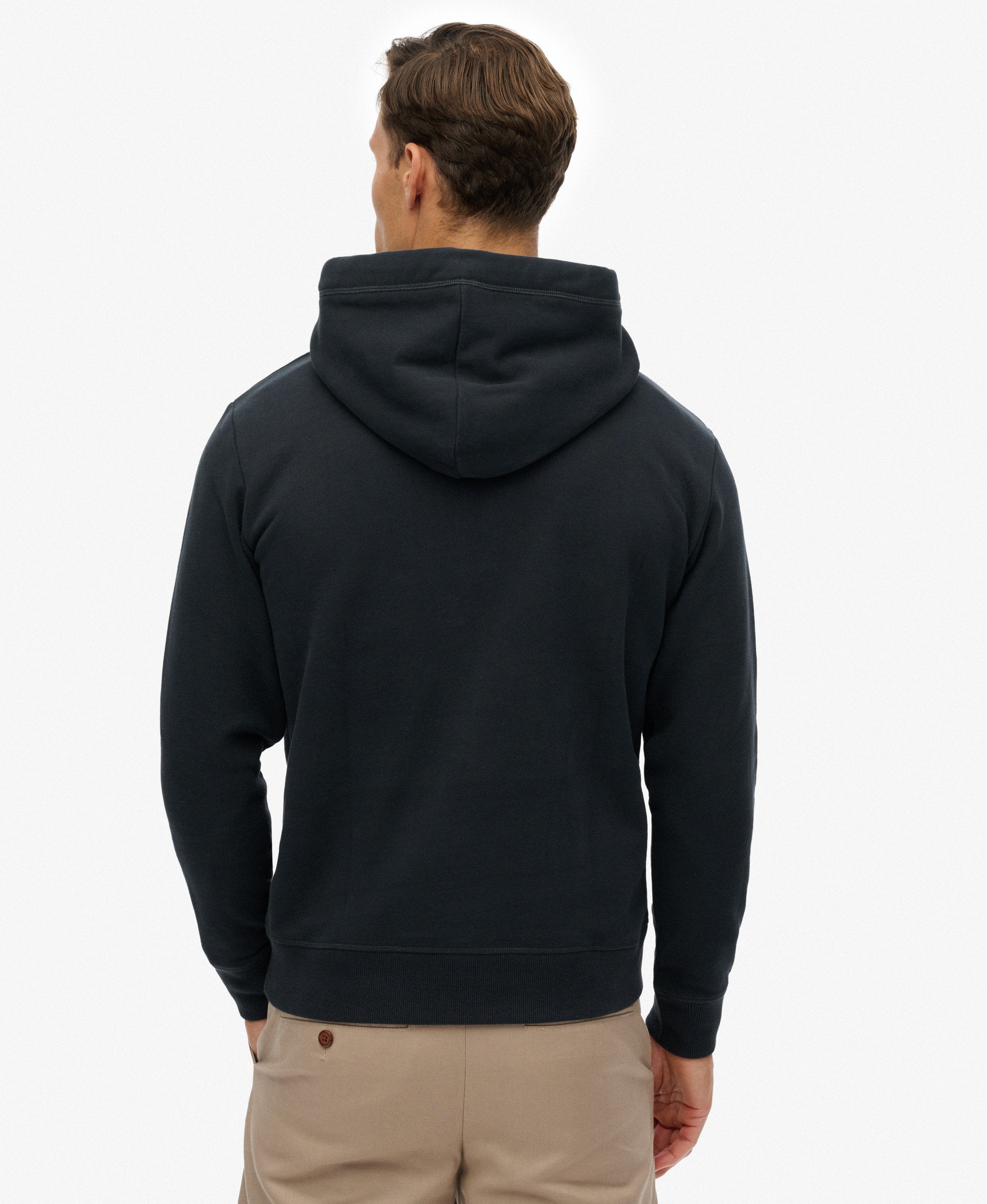 Man wearing a black hoodie from behind on a white background