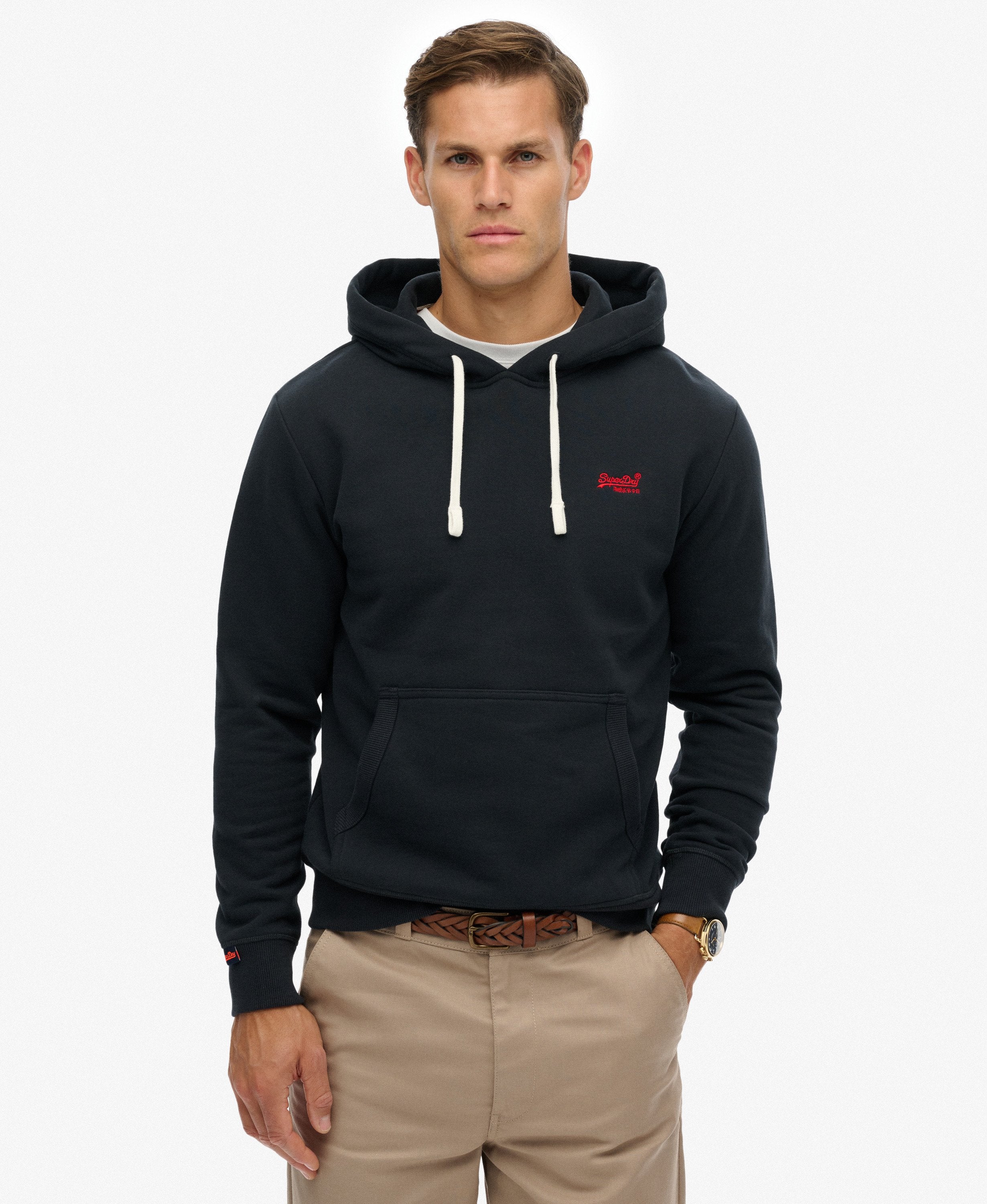 Man wearing a black hoodie with a red logo on a white background