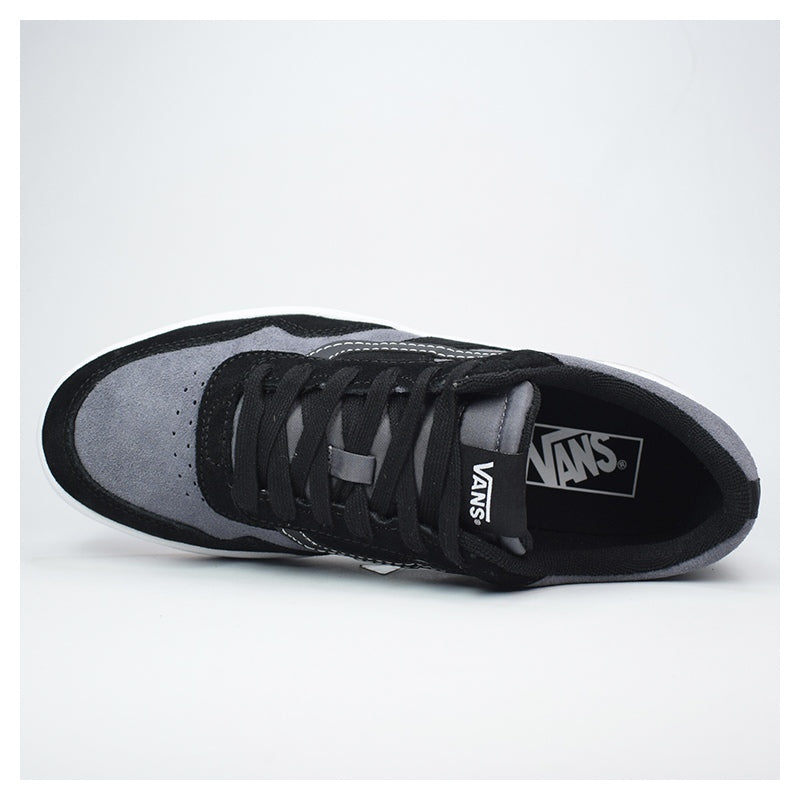 Black and gray Vans sneaker on a light gray background