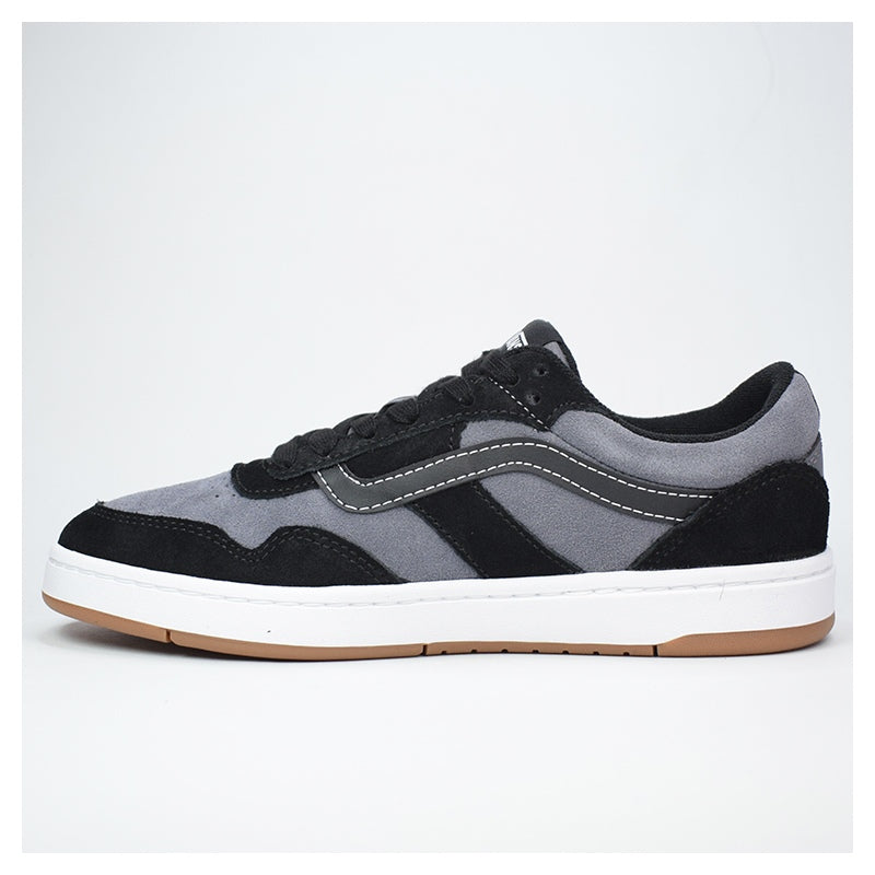 Gray and black sneaker with white sole on a light gray background