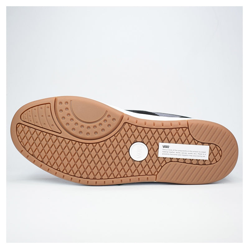 Close-up of a shoe sole with a textured pattern on a light gray background