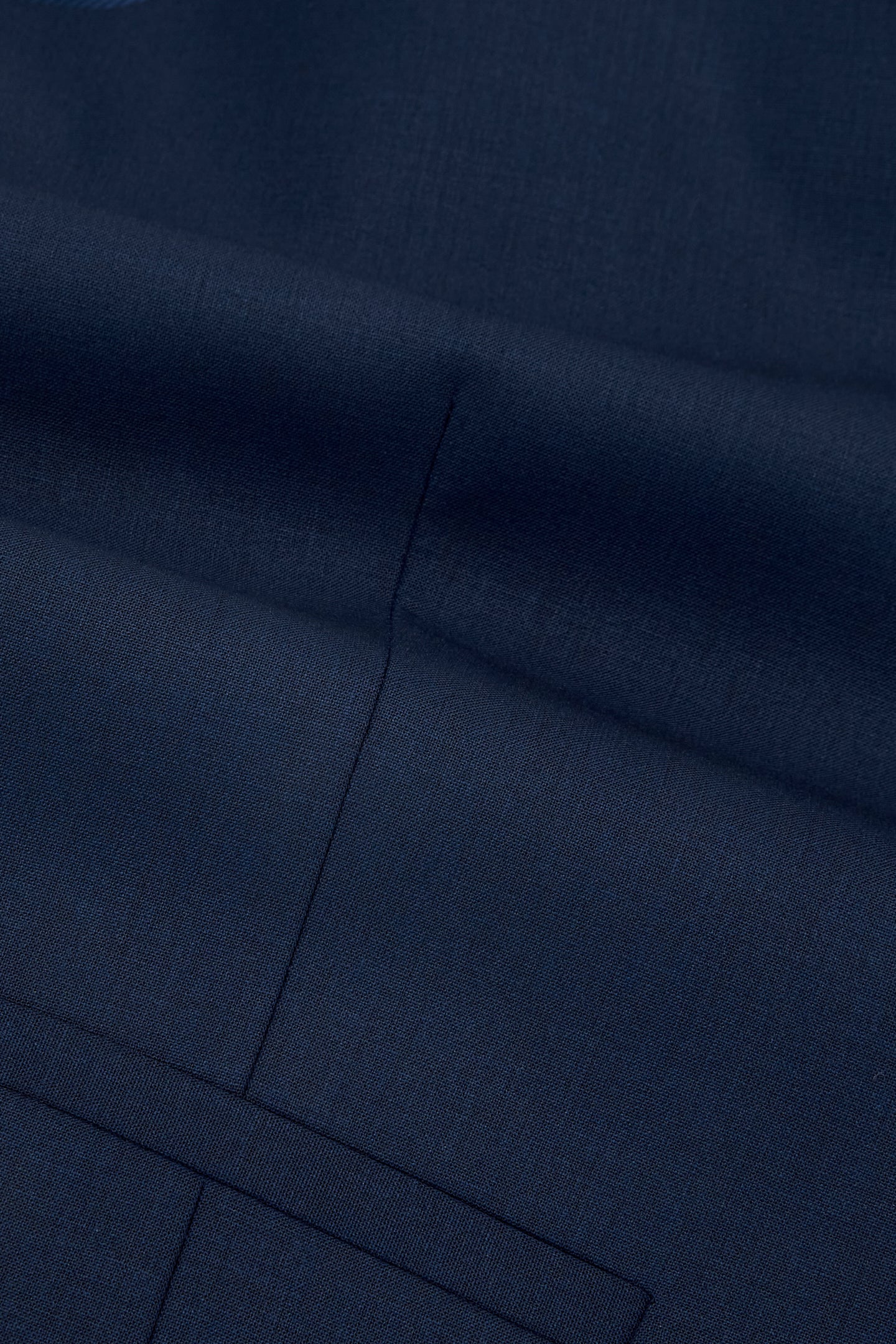 Close-up detail of men's navy tapered trousers