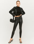 Side view of women's coated black leggings