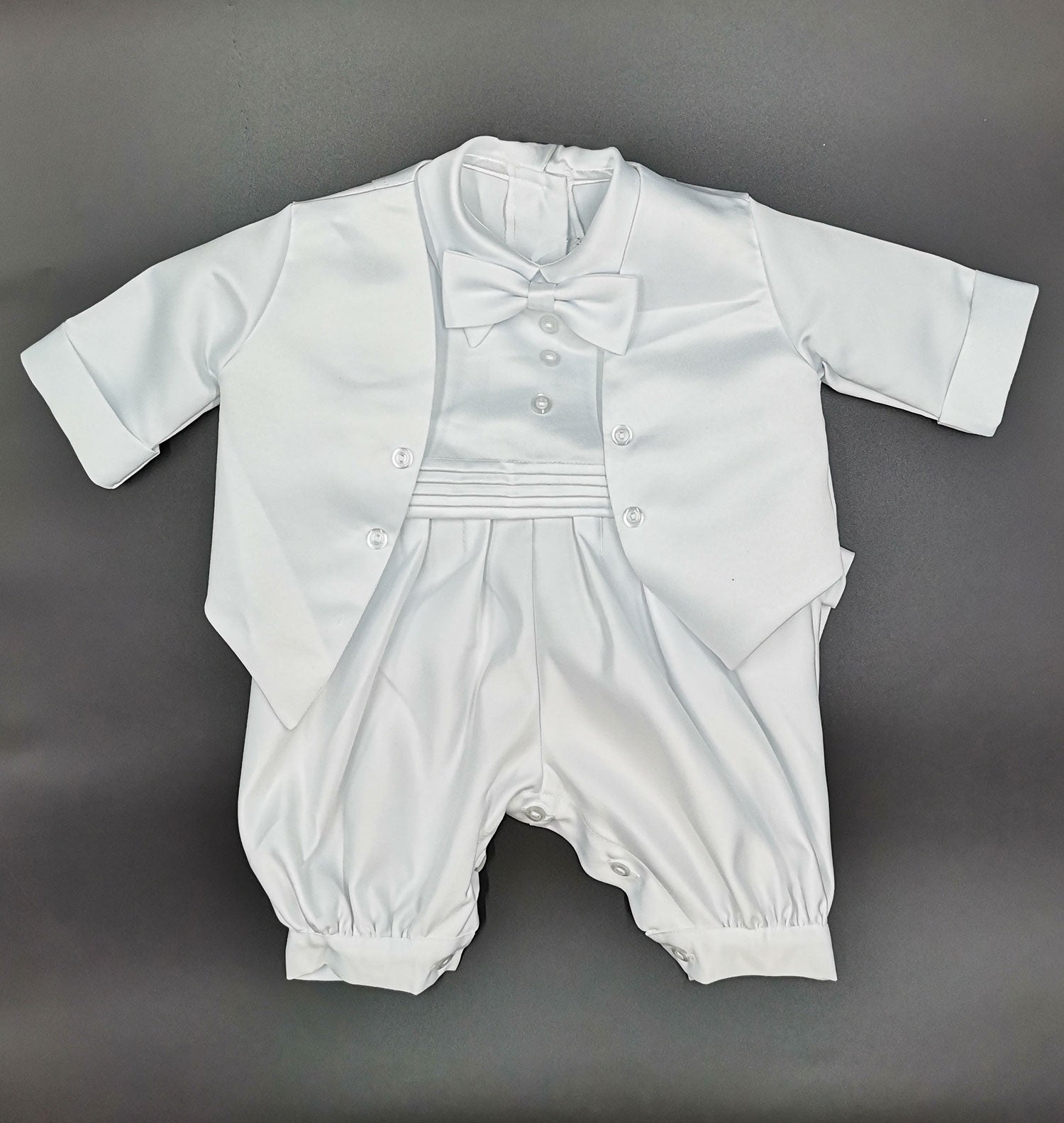 Front view of the boys white christening suit